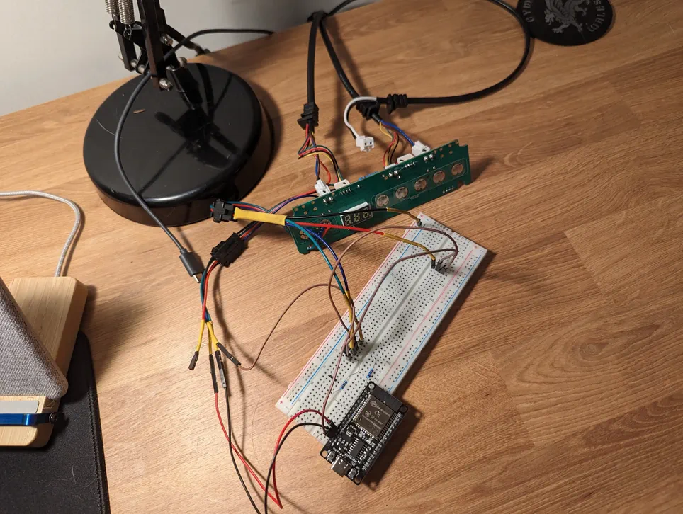 A photo of a breadboard that shows two transistors, attached to two resistors, attached to an ESP32. The wiring is chaotic.