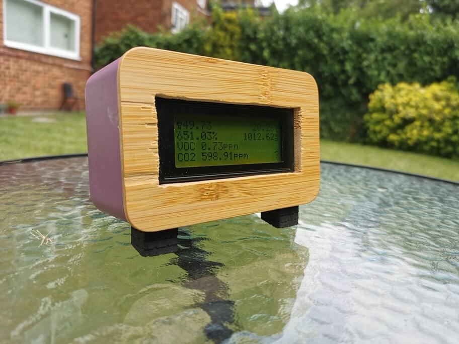The finished Air Quality Meter, a purple food storage tub with a poking through the wooden lid