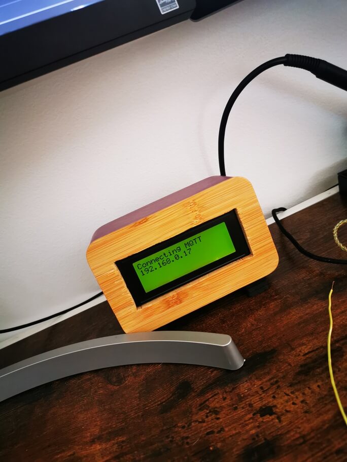 A photo of the air quality meter LCD displaying 'Connecting MQTT 192.168.0.17'