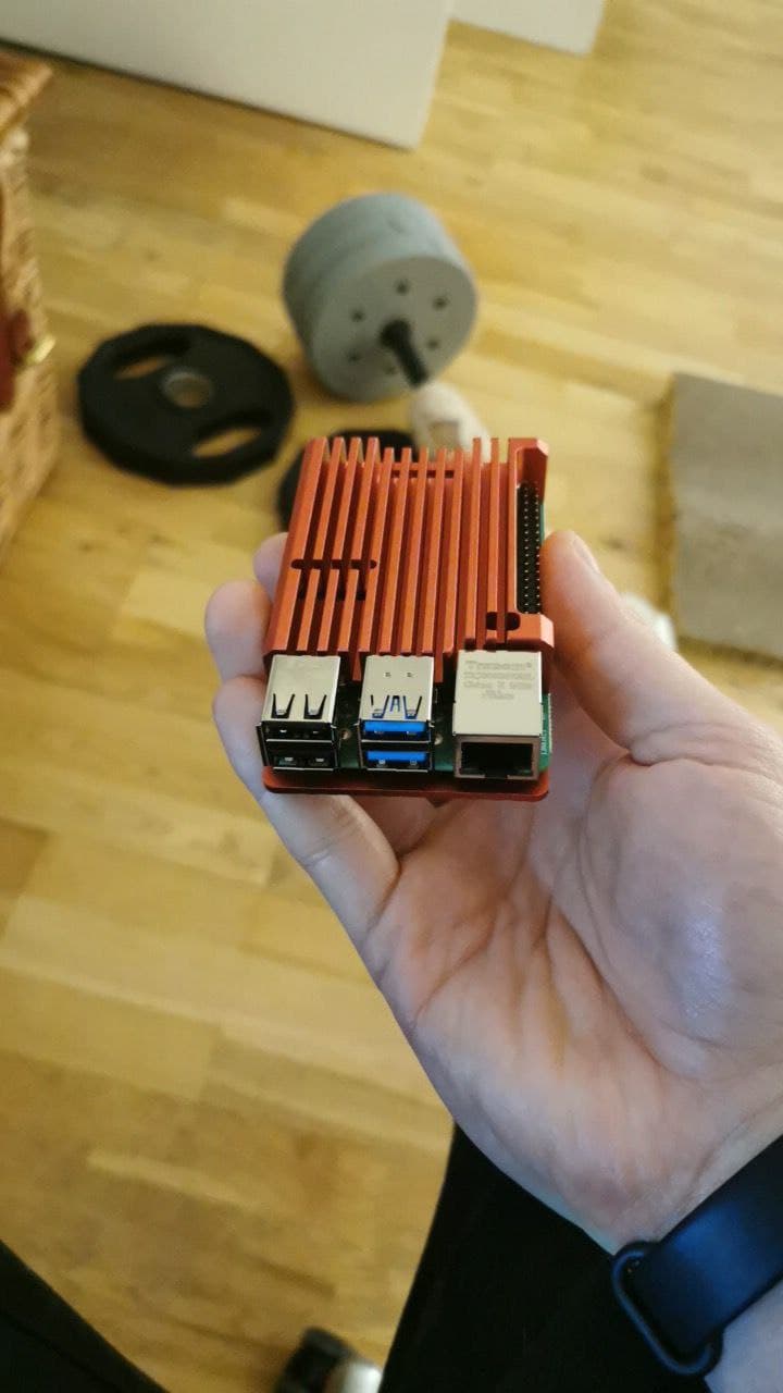 A photo of a Raspberry Pi, in a red aluminium case