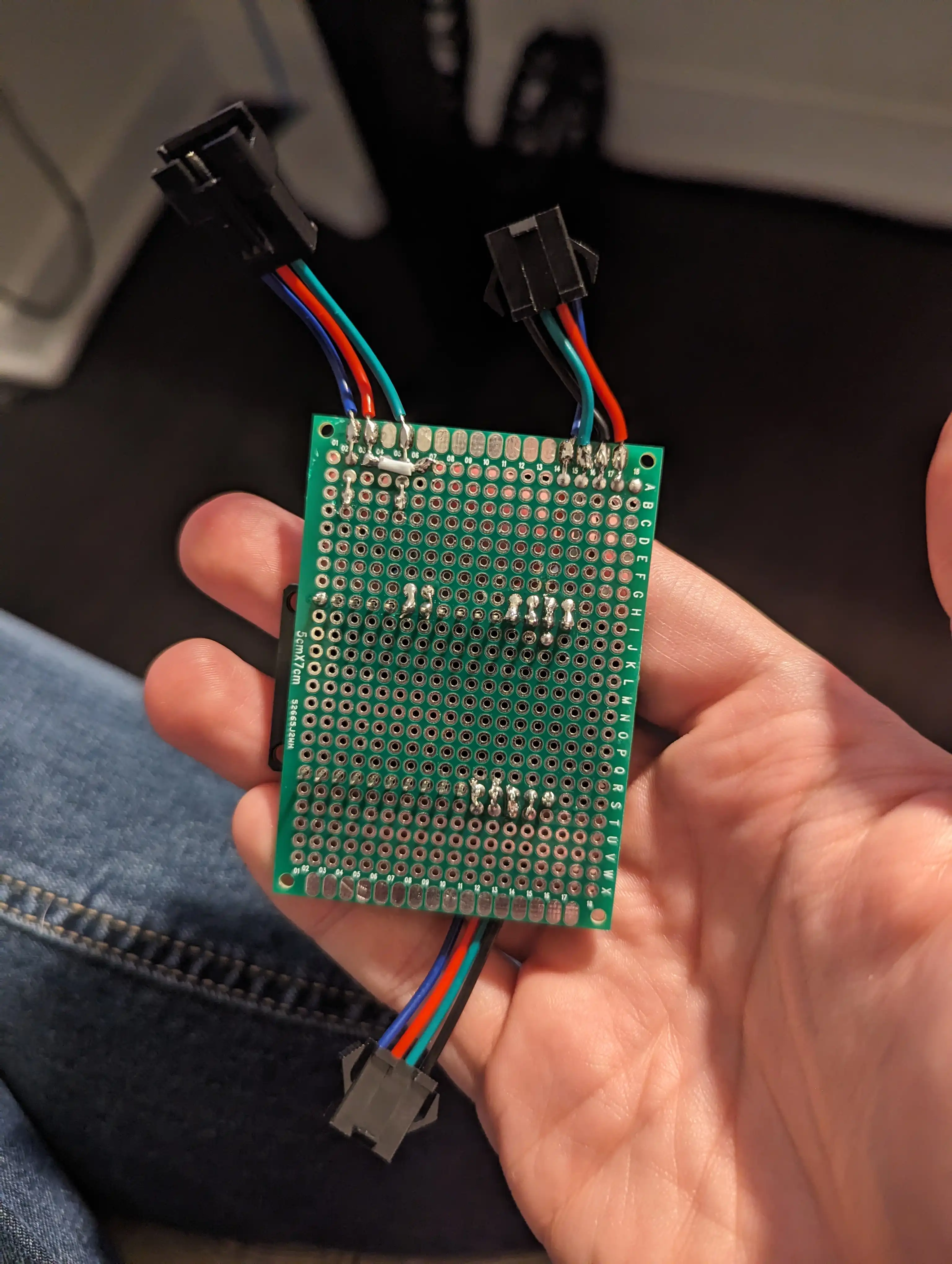 A photo of the back of a protoboard with the same wiring as the breadboard