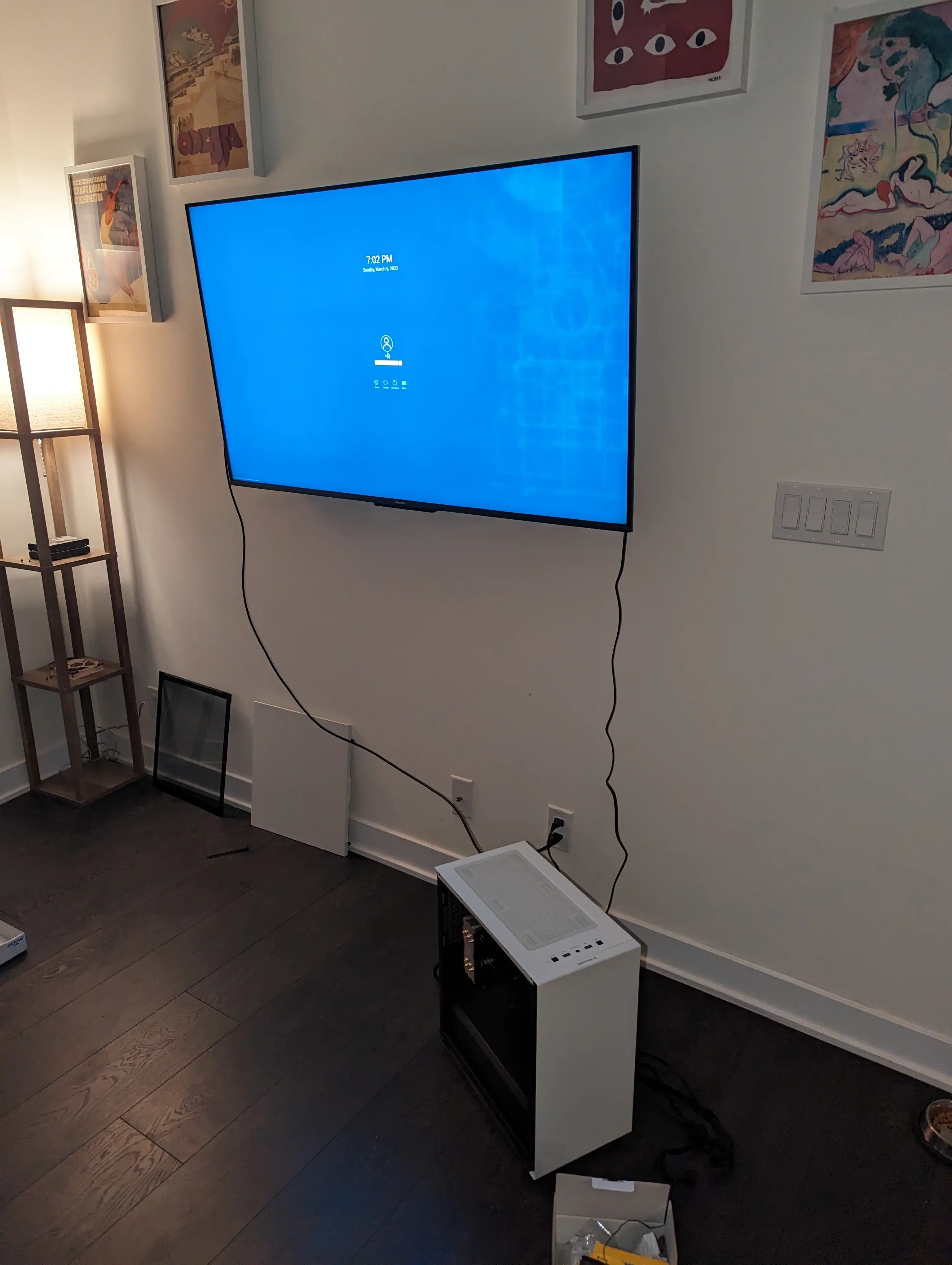A photo of the assembled computer, connected to a television, which is showing a KDE Login screen.