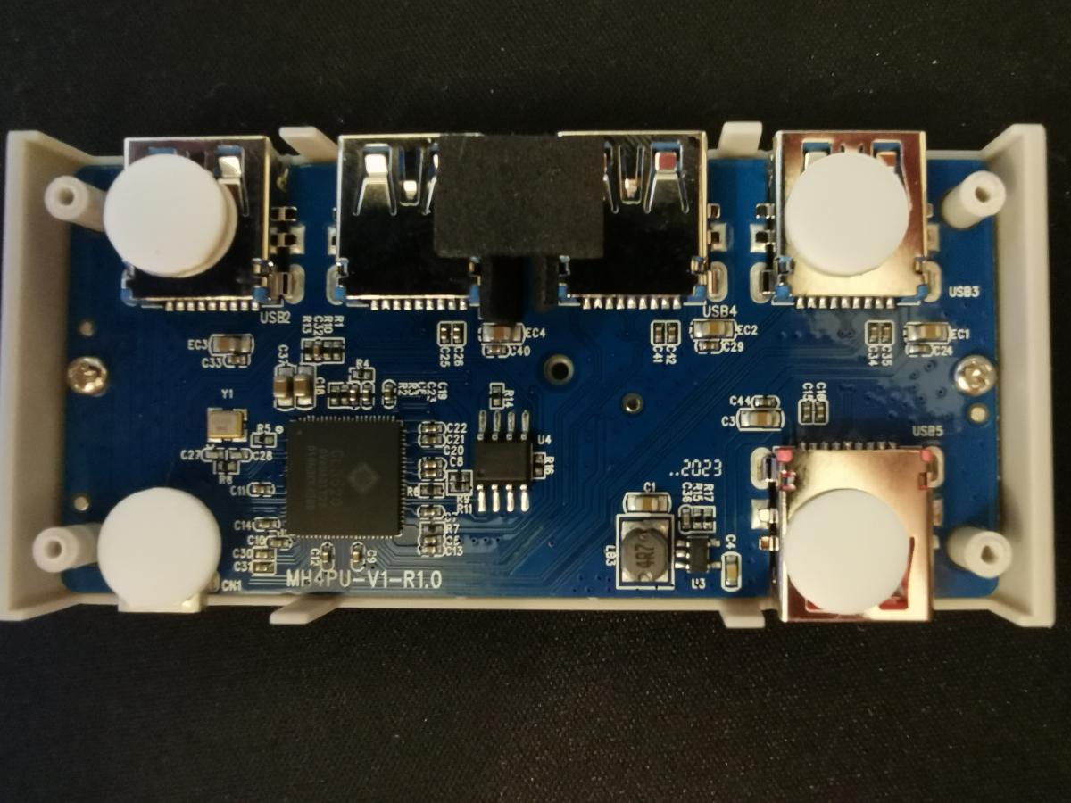 A photo of the dark blue circuit board inside the USB hub